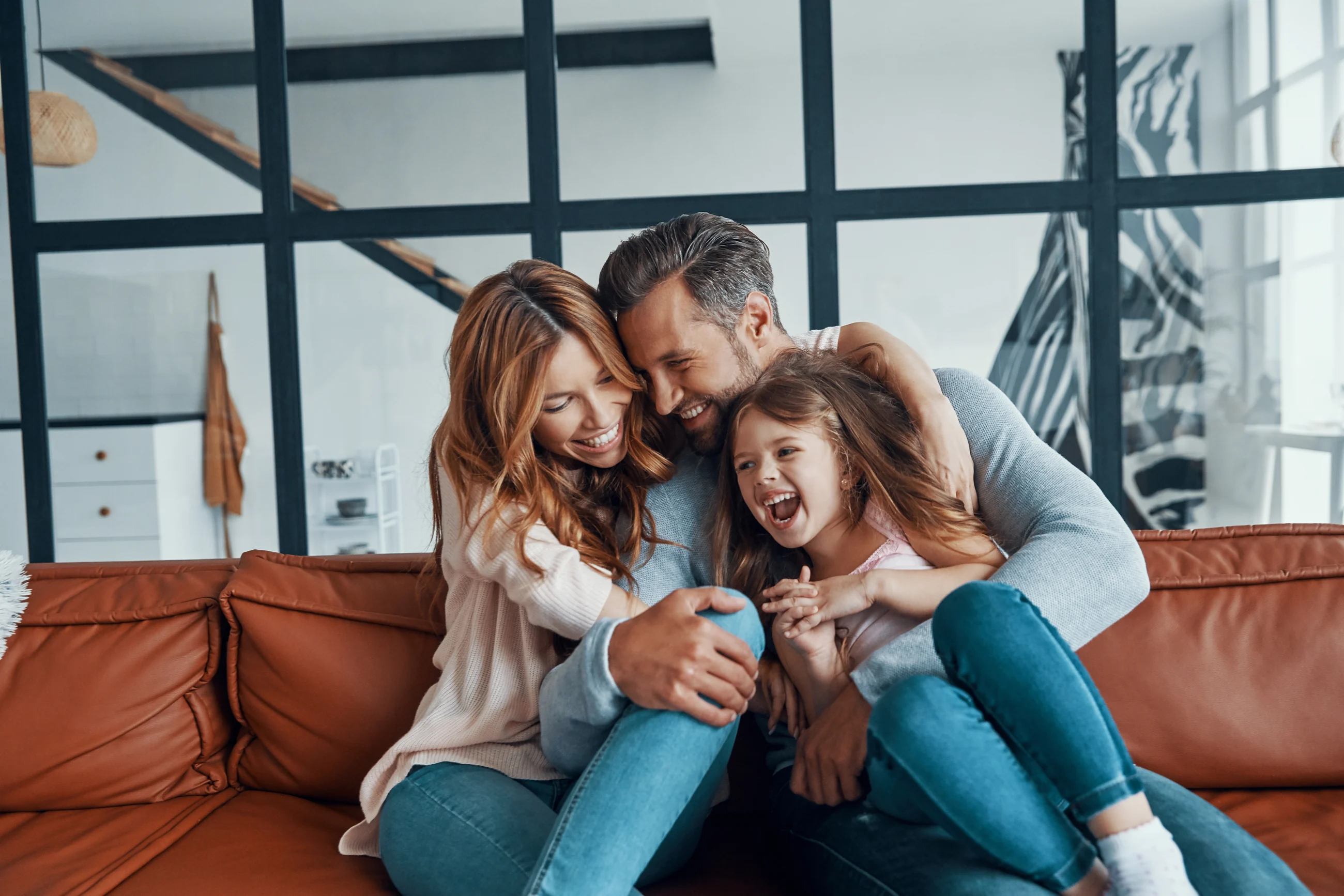 Family smiling together on a couch