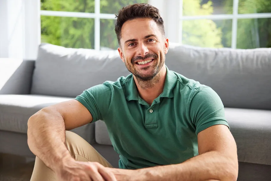 Smiling Patient Smiling man relaxing on a couch at home