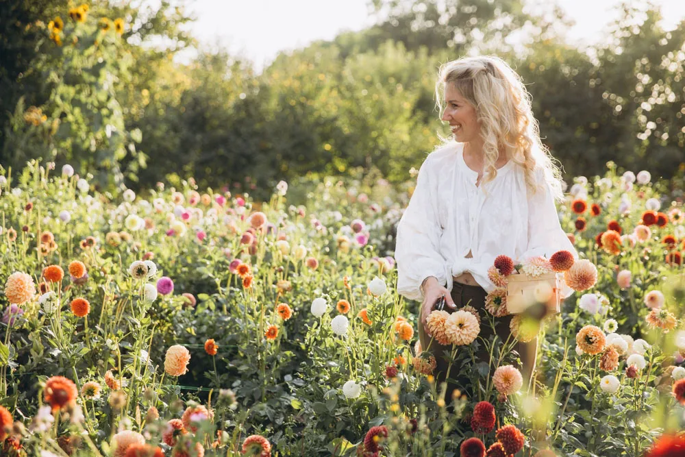Smiling Patient Smiling woman standing outdoors in a flower garden