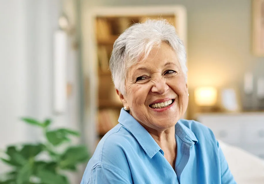 Smiling Patient Smiling older woman in a blue cardigan indoors